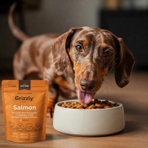 Happy dog eating grizzly salmon food supplement with omega fatty acids for healthy skin and coat.