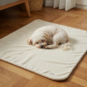 Small white dog peacefully sleeping on a cream-colored soft dog blanket indoors.
