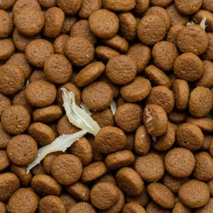 Close-up of dry whitefish dog kibble mixed with real fish shreds, showcasing texture and natural ingredients.